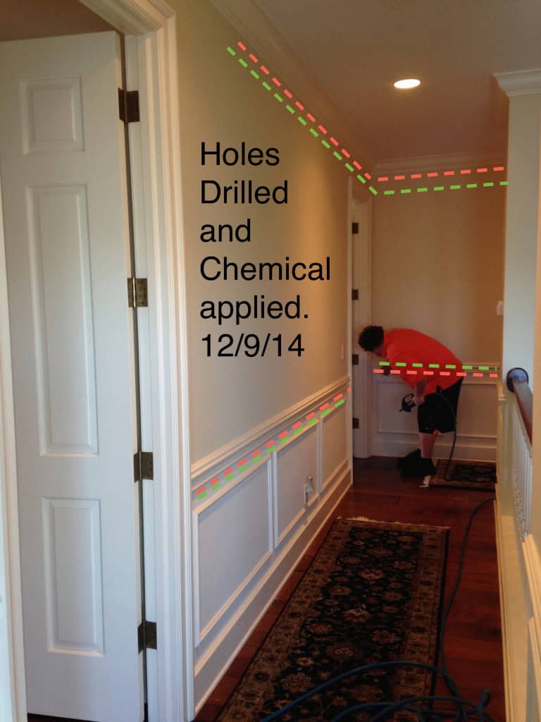 Upstairs hallway marked where holes were drilled and chemical applied